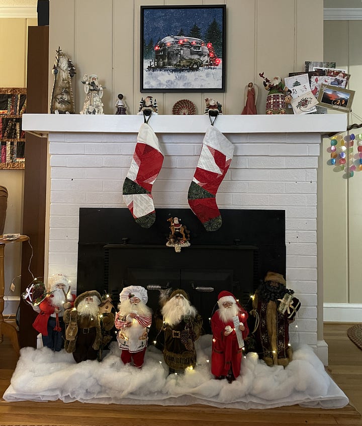 A woman sitting on a large vine in the forest and a fireplace with six different Santa Clauses, stocking, and a decorated camper picture