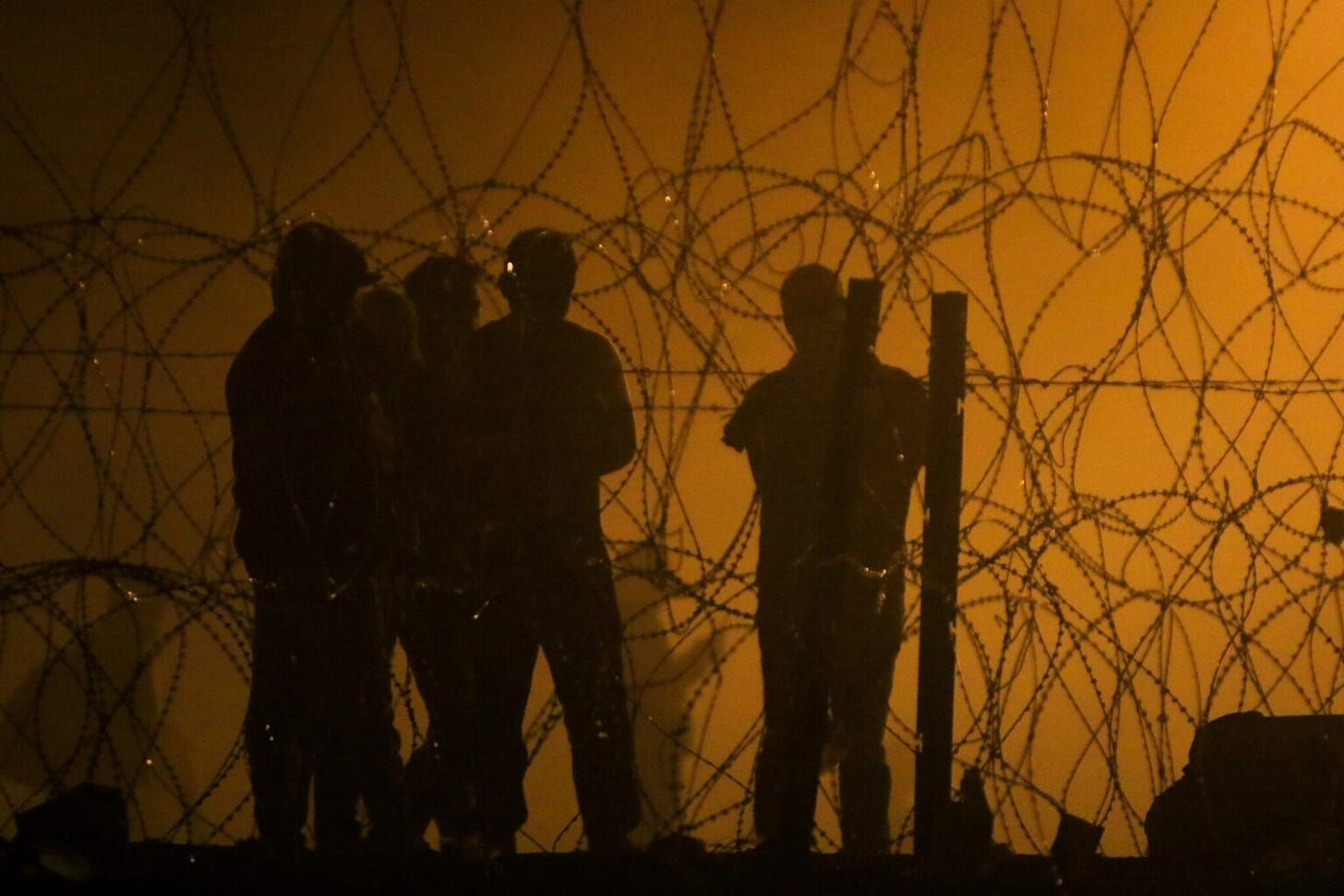 Migrants wait throughout the night on May 10, 2023, in a dust storm at Gate 42, on land between the Rio Grande and the border wall, hoping they will be processed by immigration authorities before the expiration of Title 42. (Photo by Corrie Boudreaux /Source New Mexico) Migrants wait throughout the night on May 10, 2023, in a dust storm at Gate 42, on land between the Rio Grande and the border wall, hoping they will be processed by immigration authorities before the expiration of Title 42. (Photo by Corrie Boudreaux /Source New Mexico)