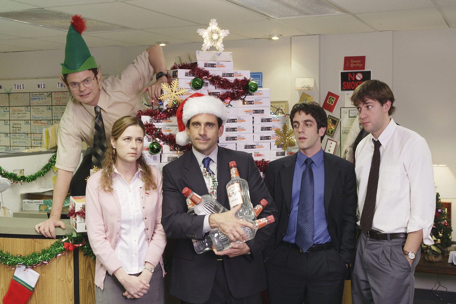 Office employees standing in front of a Christmas-themed display with decorations and holiday props, featuring mixed expressions of amusement and awkwardness at a workplace holiday party Office employees standing in front of a Christmas-themed display with decorations and holiday props, featuring mixed expressions of amusement and awkwardness at a workplace holiday party
