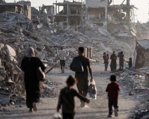 People walking towards destroyed buildings People walking towards destroyed buildings