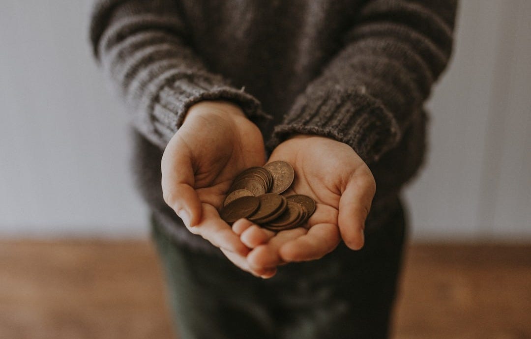 copper-colored coins on in person's hands