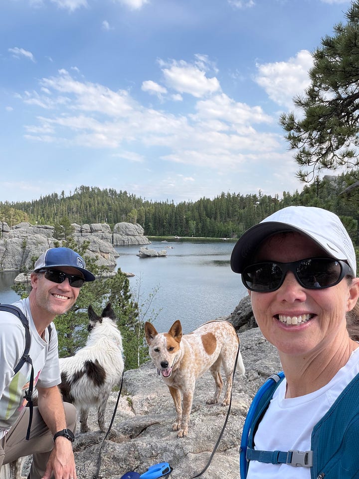 two cattle dogs, a man, and a woman in South Dakota and North Dakota