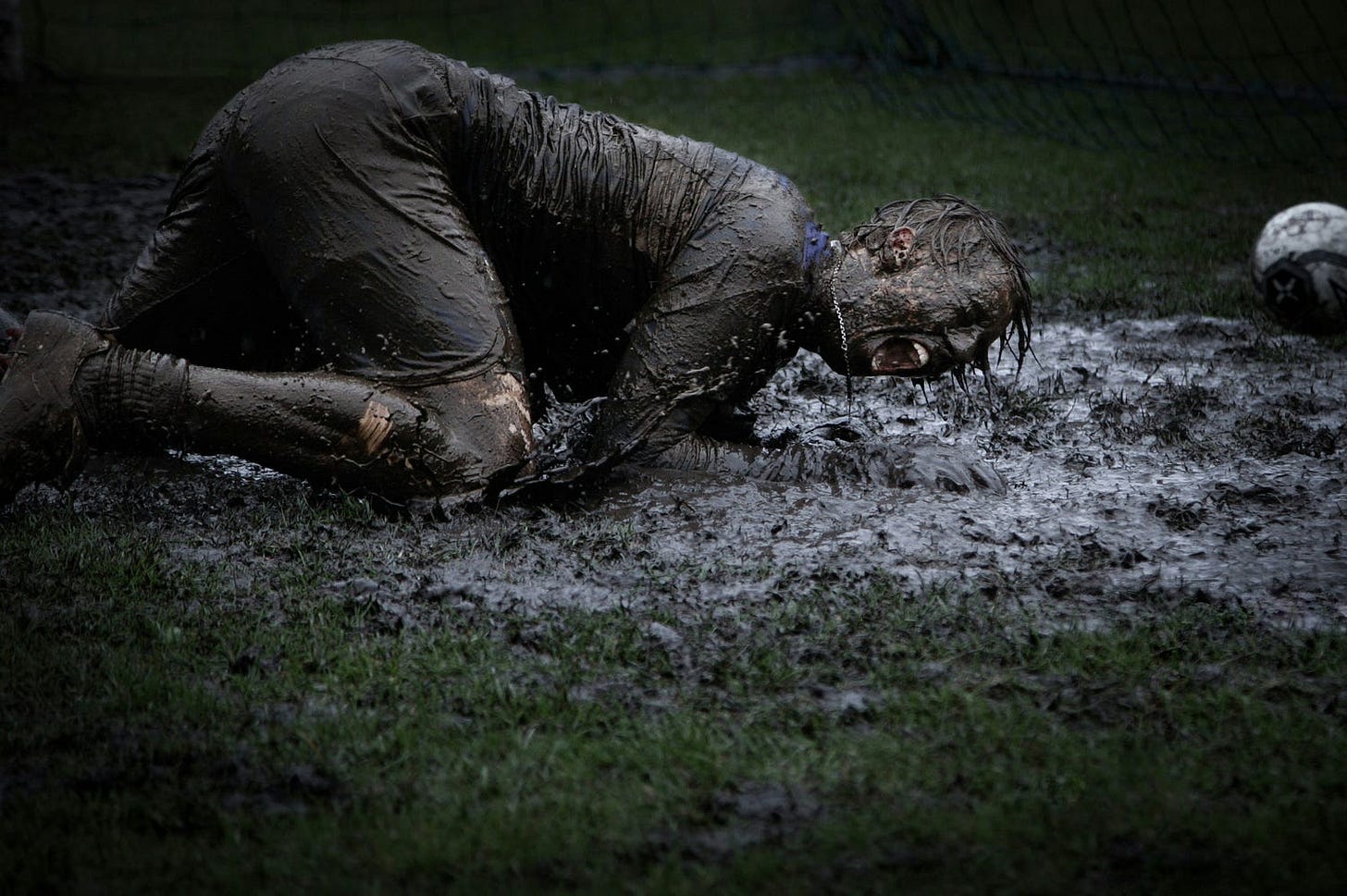 man lying in a pool of mud man lying in a pool of mud