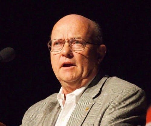 With a serious expression, Lawrence Wilkerson speaks from a podium