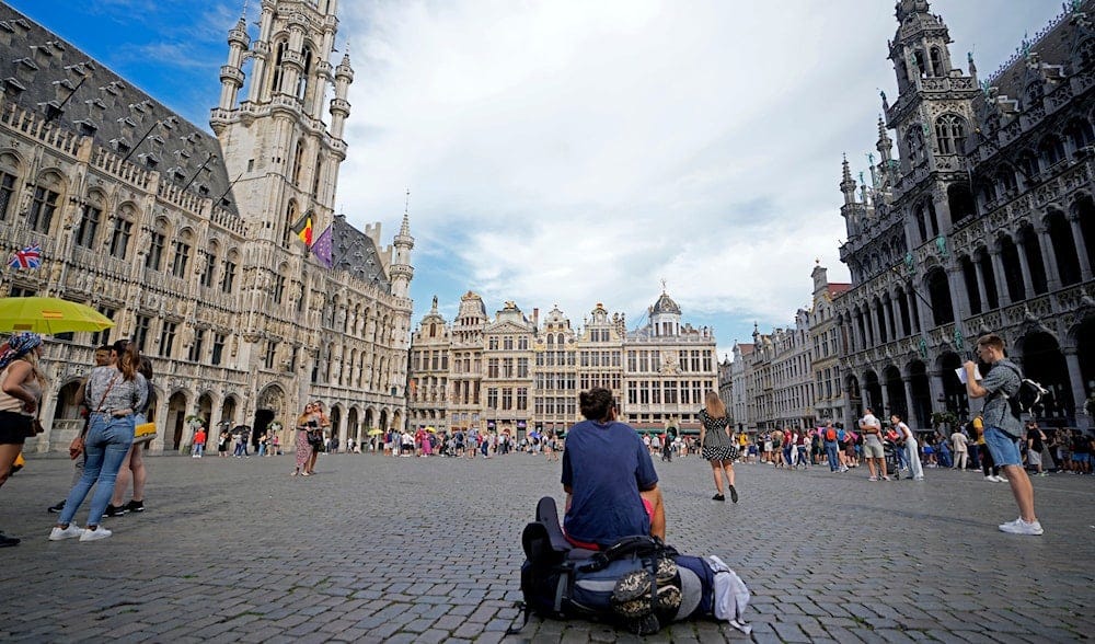 A man sits with his backpack in the center of the historical Grand Place in Brussels on Wednesday, Aug. 24, 2022. (AP Photo/Virginia Mayo) A man sits with his backpack in the center of the historical Grand Place in Brussels on Wednesday, Aug. 24, 2022. (AP Photo/Virginia Mayo)