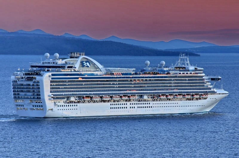 A picture of the vast 3000-passenger cruise ship, sailing on calm waters with blue mountains in the background and a dark red sky. A picture of the vast 3000-passenger cruise ship, sailing on calm waters with blue mountains in the background and a dark red sky.