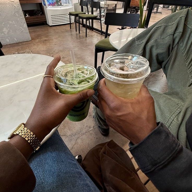 This may contain: a man is holding a drink in his hand