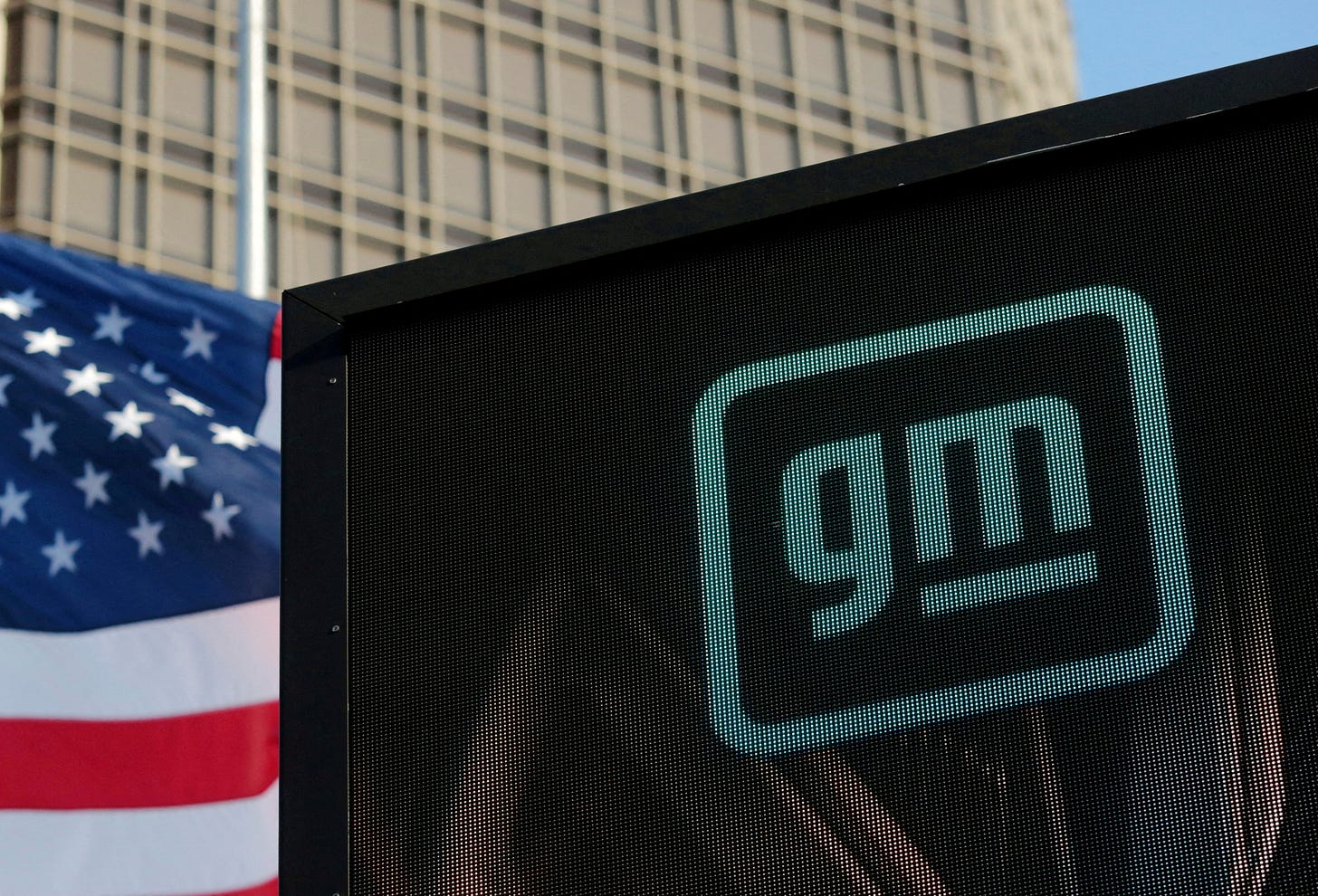 Logo of GM atop the company headquarters Logo of GM atop the company headquarters