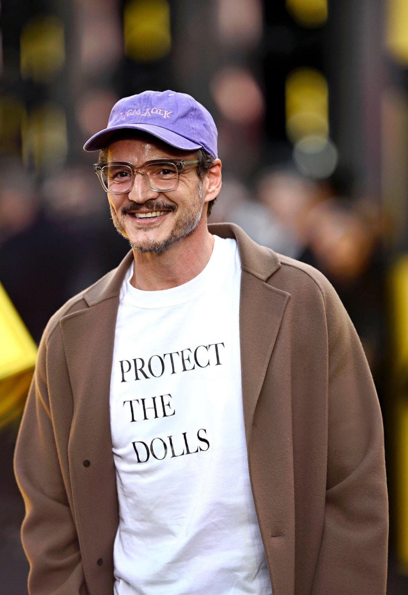 Pedro Pascal wearing a 'Protect the Dolls' t-shirt while attending the  premiere of 'Thunderbolts*' in London. All proceeds from the sale of the  shirt are donated directly to Trans Lifeline, a trans-lead