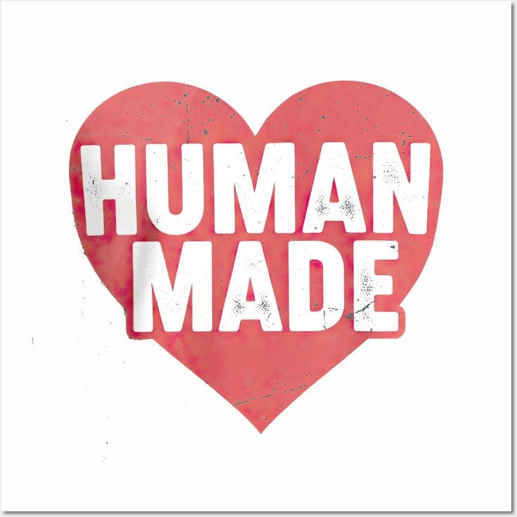 This may contain: a red heart with the words human made on it