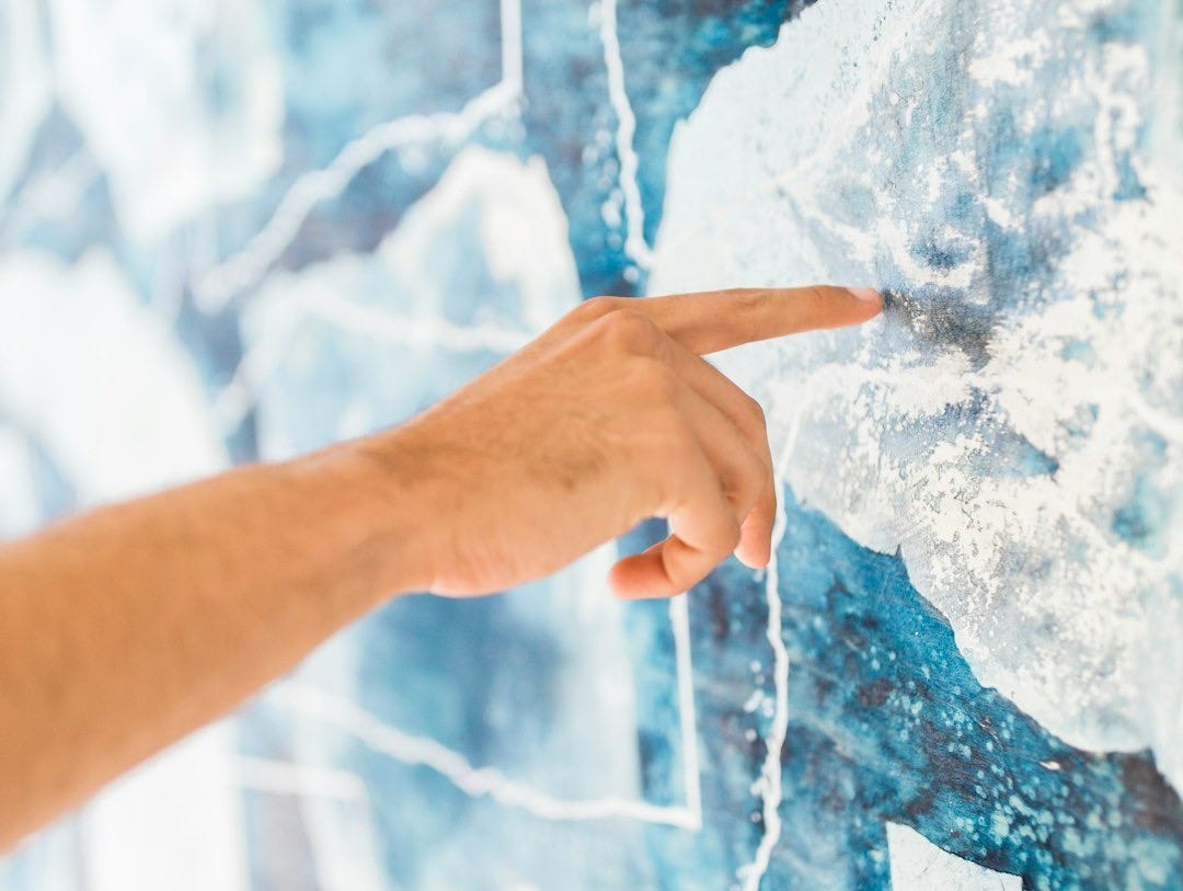 person holding blue and white paint person holding blue and white paint