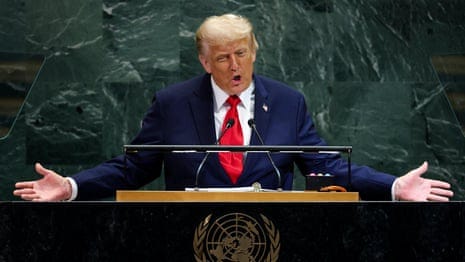 a man in a suit speaks into a microphone