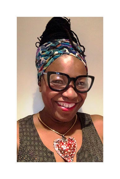 A person wearing glasses and a head scarf

Description automatically generated with low confidence