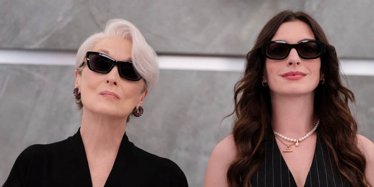 Miranda Priestly (Meryl Streep) and Andy Sachs (Anne Hathaway) pictured in an elevator wearing sunglasses. Miranda Priestly (Meryl Streep) and Andy Sachs (Anne Hathaway) pictured in an elevator wearing sunglasses.