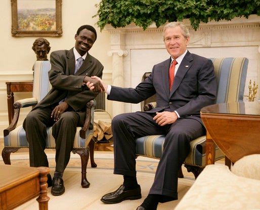 President George W. Bush welcomes Sudanese Liberation Movement leader Minni Minnawi to the Oval Office Tuesday, July 25, 2006, in Washington, D.C., meeting to discuss the Darfur region of western Sudan. White House photo by Kimberlee Hewitt President George W. Bush welcomes Sudanese Liberation Movement leader Minni Minnawi to the Oval Office Tuesday, July 25, 2006, in Washington, D.C., meeting to discuss the Darfur region of western Sudan. White House photo by Kimberlee Hewitt