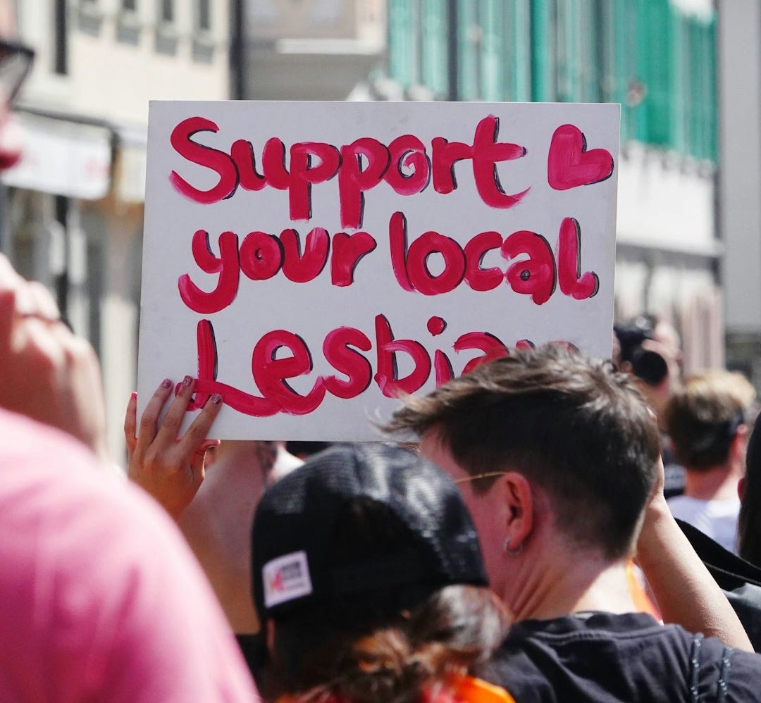 a group of people holding a sign