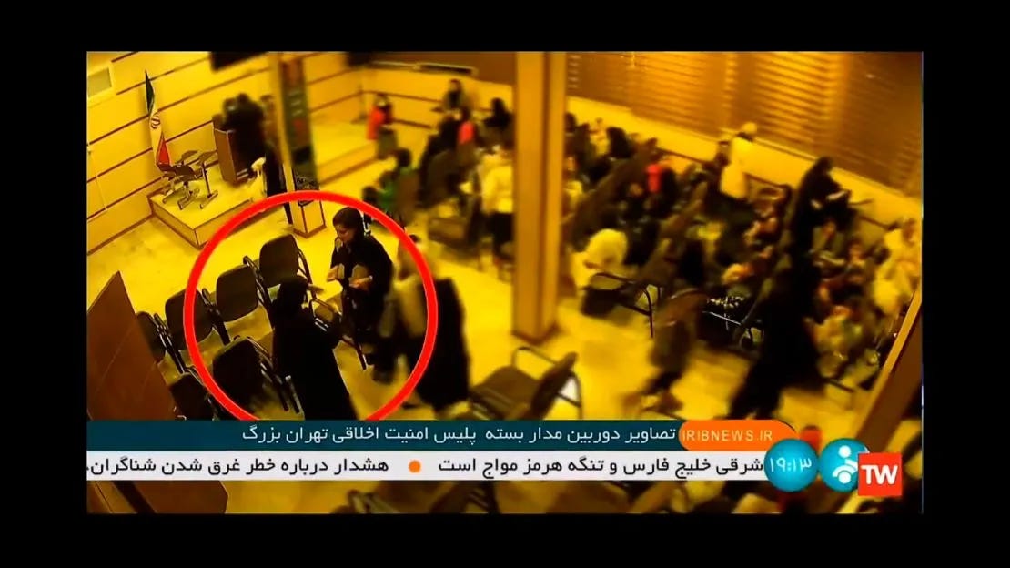 A video, released by Iranian state TV, shows the alleged moment that 22 year-old Mahsa Amini, facing the camera in the red circle, collapses after being arrested by Iran's "morality police." A video, released by Iranian state TV, shows the alleged moment that 22 year-old Mahsa Amini, facing the camera in the red circle, collapses after being arrested by Iran's "morality police."