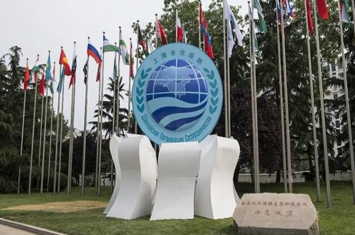 A group of flags in front of a sign

AI-generated content may be incorrect.