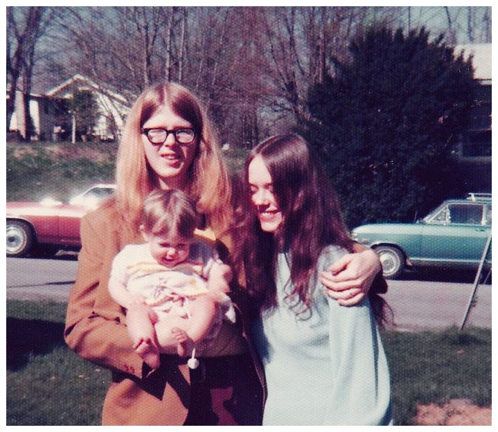 Photo of baby me, my mom, and my dad