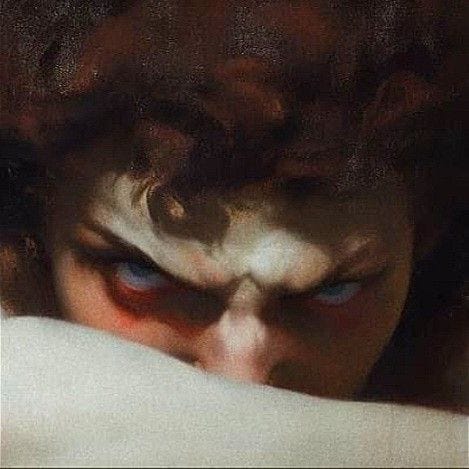 This may contain: an image of a woman with blue eyes looking at something in her hand while she covers her face