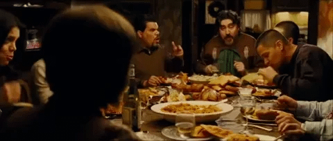 People gathered around a big table having dinner and arguing. People gathered around a big table having dinner and arguing.