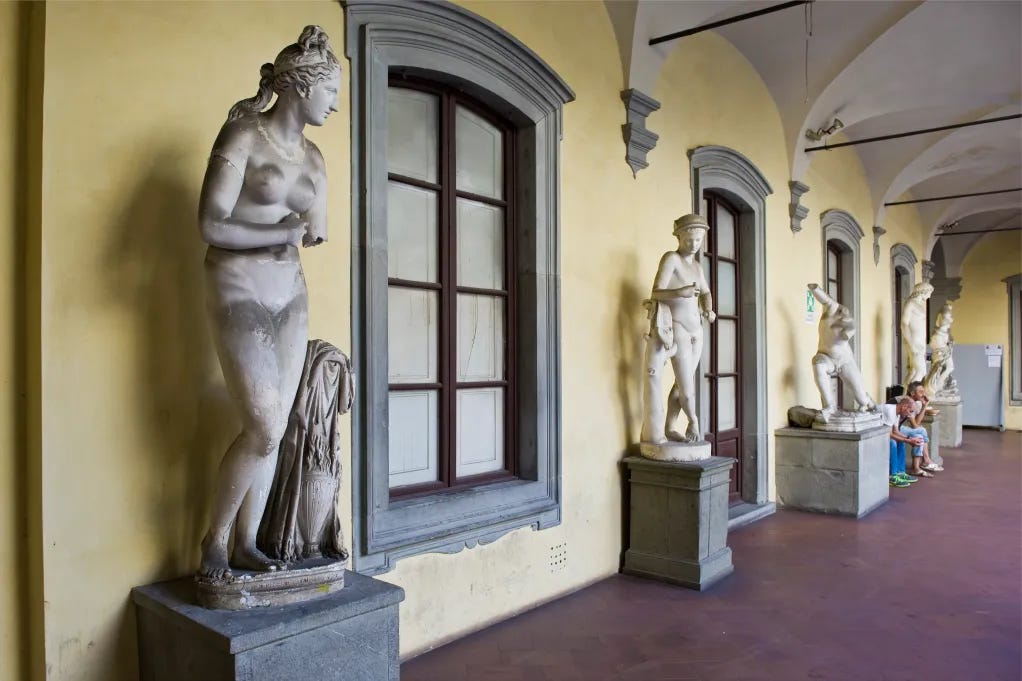 Nude statues lining the outside of the academy, underscoring the academy's rich history of figurative art. 