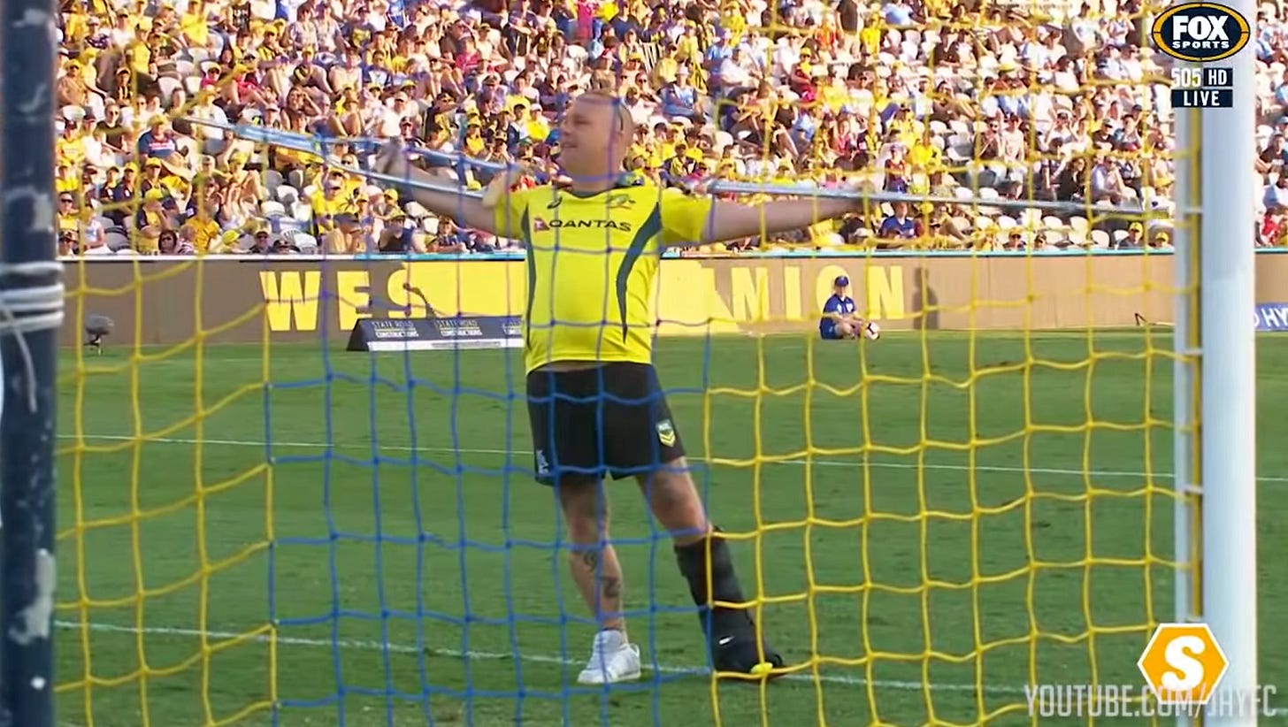 A Central Coast Mariners fan with crutches and a moon boot in the goal mouth at Central Coast Stadium