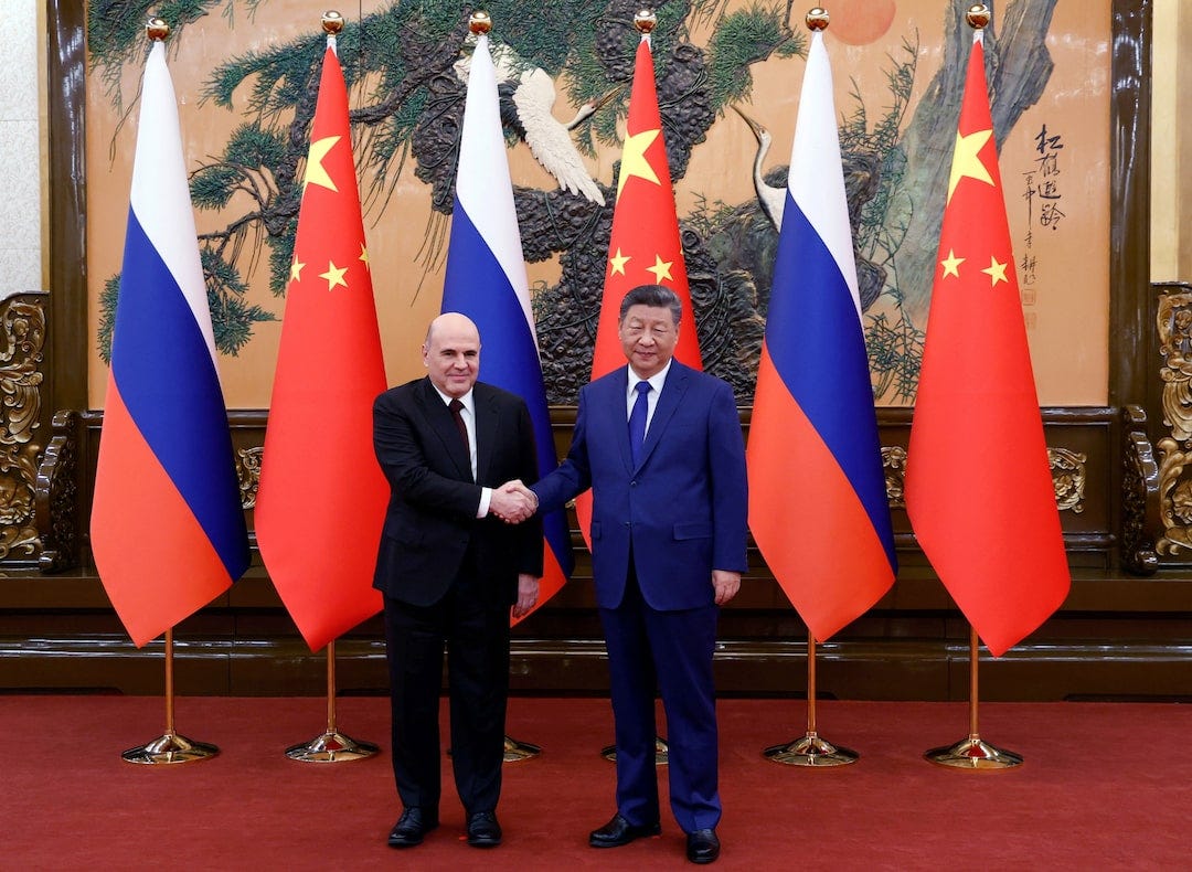 China, Russia vow joint response to 'unilateral' sanctions during Russian PM  visit | Reuters
