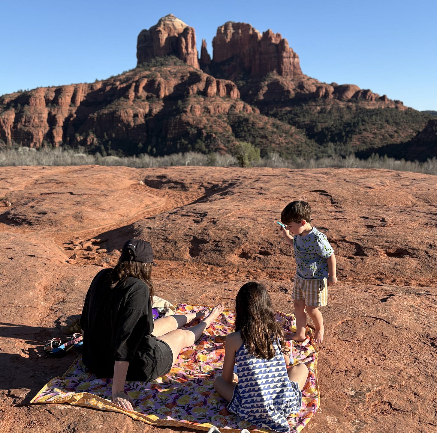 Cathedral Rock in the background at Secret Slickrock, a quiet sunset photography spot in Sedona.