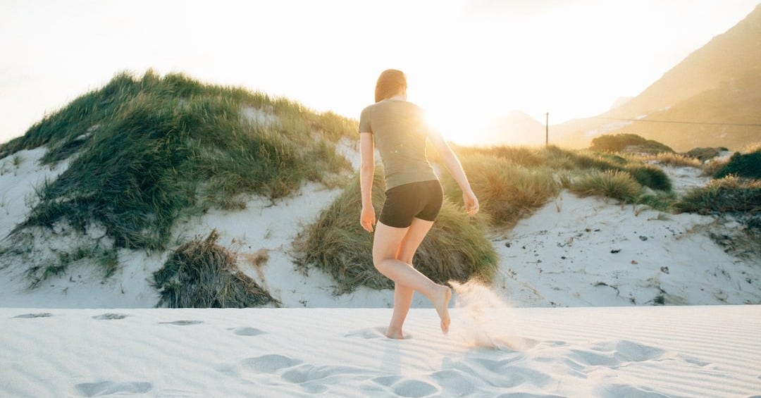woman standing on white stand during golden hour