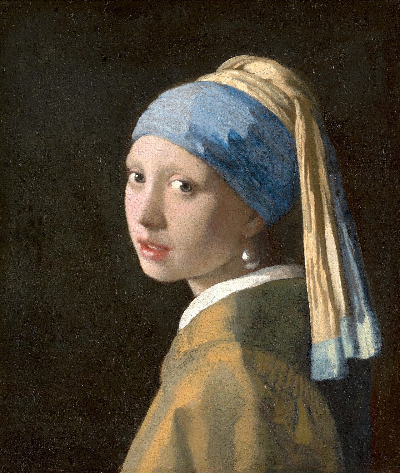 Vermeer's Girl with a Pearl Earring, a young woman turning toward the viewer Vermeer's Girl with a Pearl Earring, a young woman turning toward the viewer