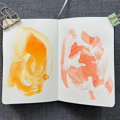 Different pages in a small sketchbook painted with light washes of watercolor in a variety colors