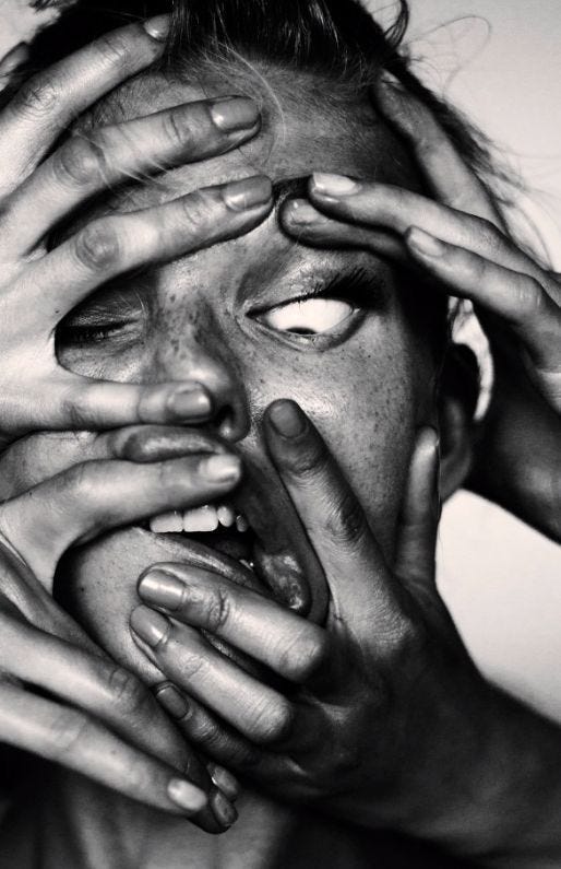 This may contain: black and white photograph of woman covering her face with hands while looking at the camera This may contain: black and white photograph of woman covering her face with hands while looking at the camera