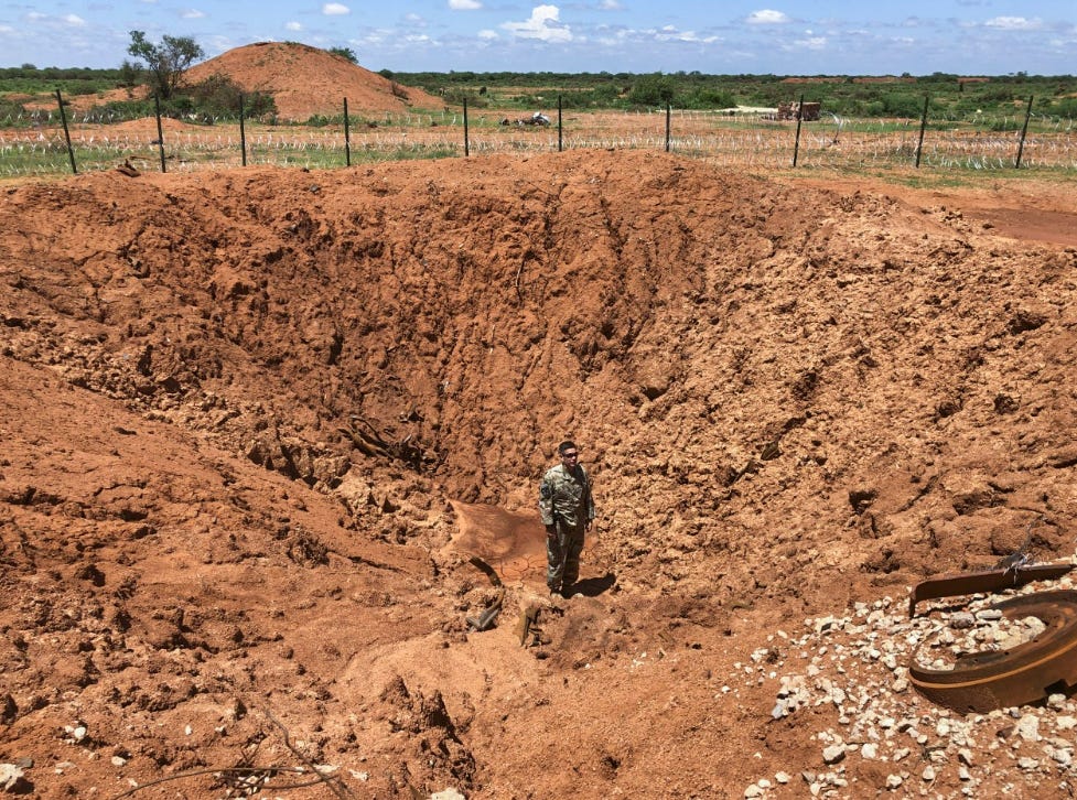 A U.S. Army Soldier with Charlie Troop, 1st Squadron, 102nd Cavalry Regiment, New Jersey Army National Guard, stands in a crater created by a Vehicle-Borne Improvised Explosive Device at Baledogle Military Airfield, Federal Republic of Somalia, Sept. 30, 2019. The base was attacked by Al-Shabaab militants that same day. The attack, which included three VBIEDs and an assault by the militants, was foiled by the Charlie Troop Soldiers. All the militants were killed and no American and Somali soldiers were seriously injured. This was largest battle against Al-Shabaab militants by American forces since Operation Gothic Serpent in 1993. The 102nd was part of the New Jersey Army National Guard’s Task Force Warrior deployment in support of Combined Joint Task Force – Horn of Africa. (U.S Army photo by Capt. London Nagai) A U.S. Army Soldier with Charlie Troop, 1st Squadron, 102nd Cavalry Regiment, New Jersey Army National Guard, stands in a crater created by a Vehicle-Borne Improvised Explosive Device at Baledogle Military Airfield, Federal Republic of Somalia, Sept. 30, 2019. The base was attacked by Al-Shabaab militants that same day. The attack, which included three VBIEDs and an assault by the militants, was foiled by the Charlie Troop Soldiers. All the militants were killed and no American and Somali soldiers were seriously injured. This was largest battle against Al-Shabaab militants by American forces since Operation Gothic Serpent in 1993. The 102nd was part of the New Jersey Army National Guard’s Task Force Warrior deployment in support of Combined Joint Task Force – Horn of Africa. (U.S Army photo by Capt. London Nagai)