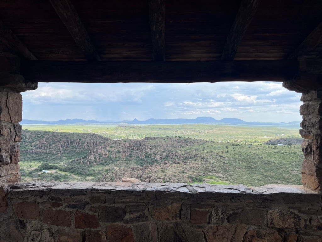 A view of a valley from a stone building

Description automatically generated