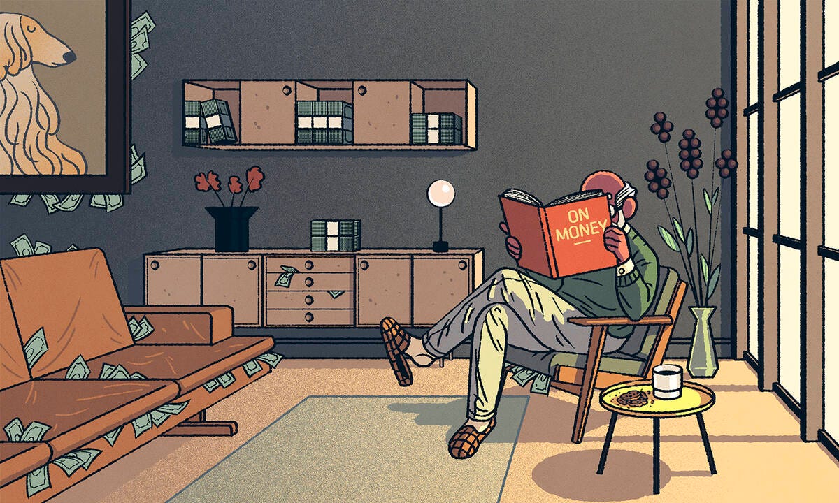 Man reading financial literacy book in living room.