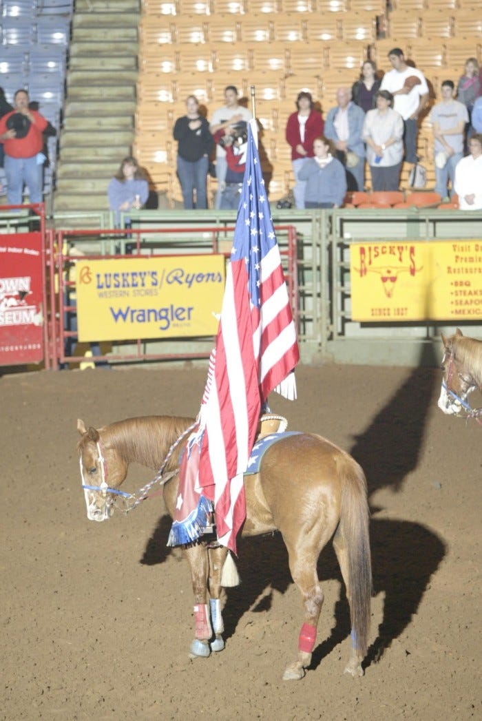 Primary view of object titled '[Event at the Cowtown Coliseum, woman flag bearer]'.