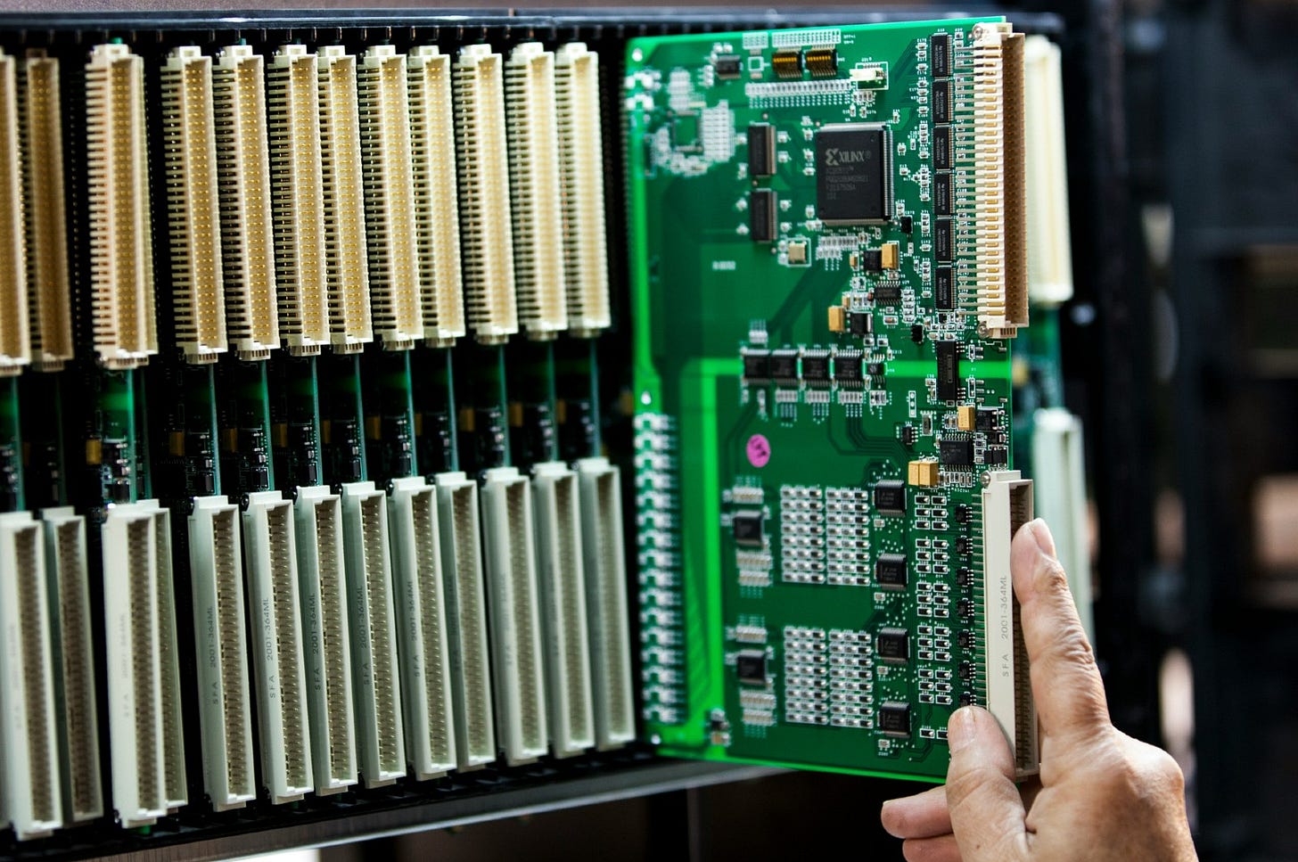 man pulling out a motherborad from a data rack man pulling out a motherborad from a data rack