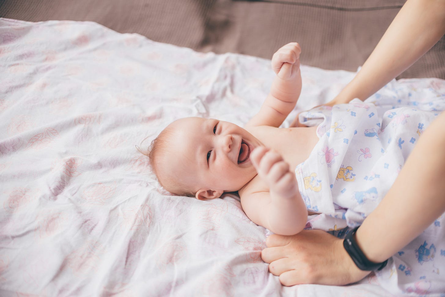 smiling baby on bed