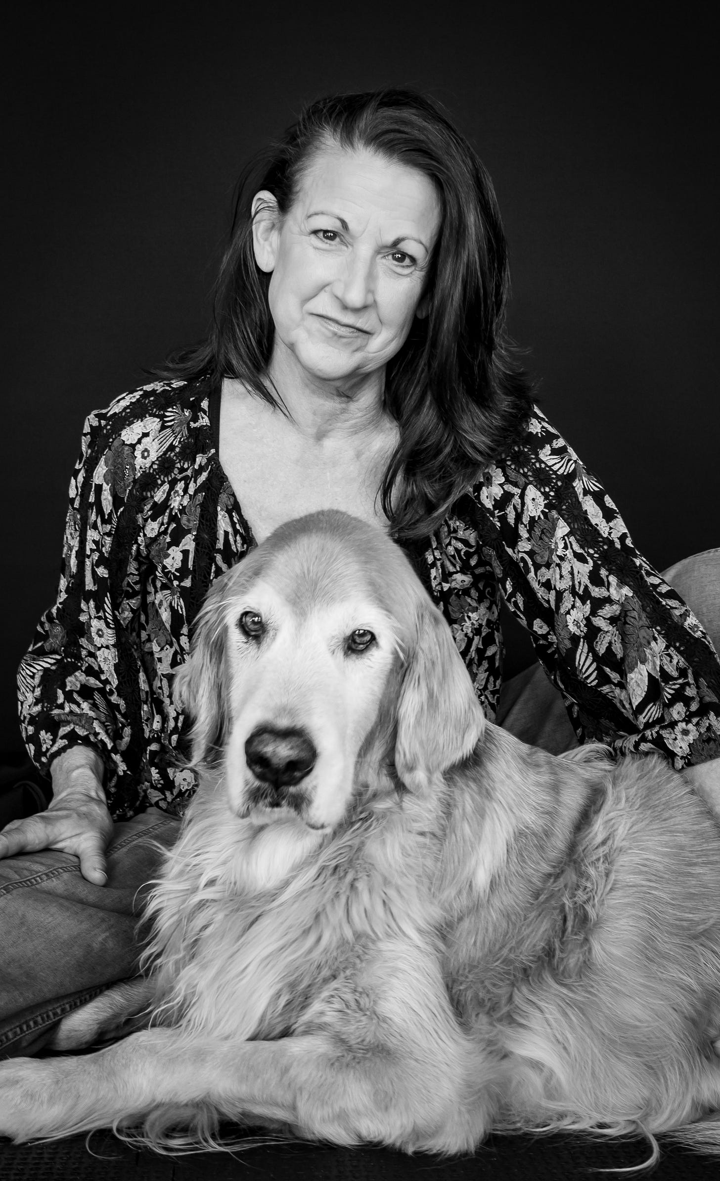 A black and white portrait of a woman and her dog. A black and white portrait of a woman and her dog.