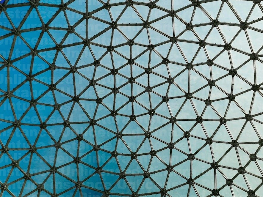 a close up of a metal structure with a blue sky in the background