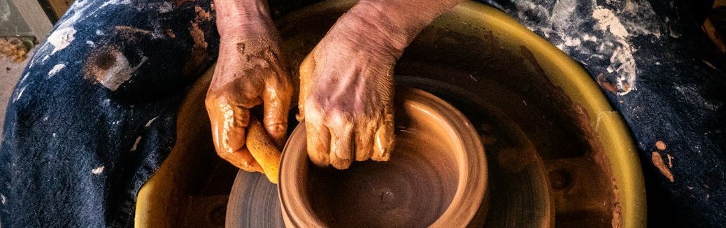 person in blue denim jeans making clay pot person in blue denim jeans making clay pot