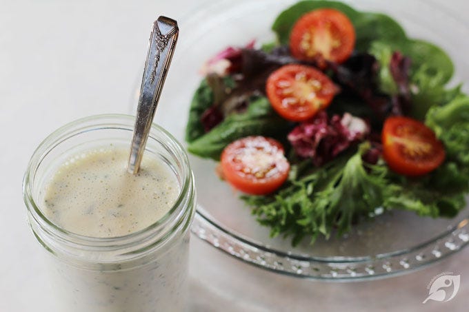 Homestyle Ranch Dressing & Dip Mix in a jar with a fresh green salad on a plate in the background. Homestyle Ranch Dressing & Dip Mix in a jar with a fresh green salad on a plate in the background.