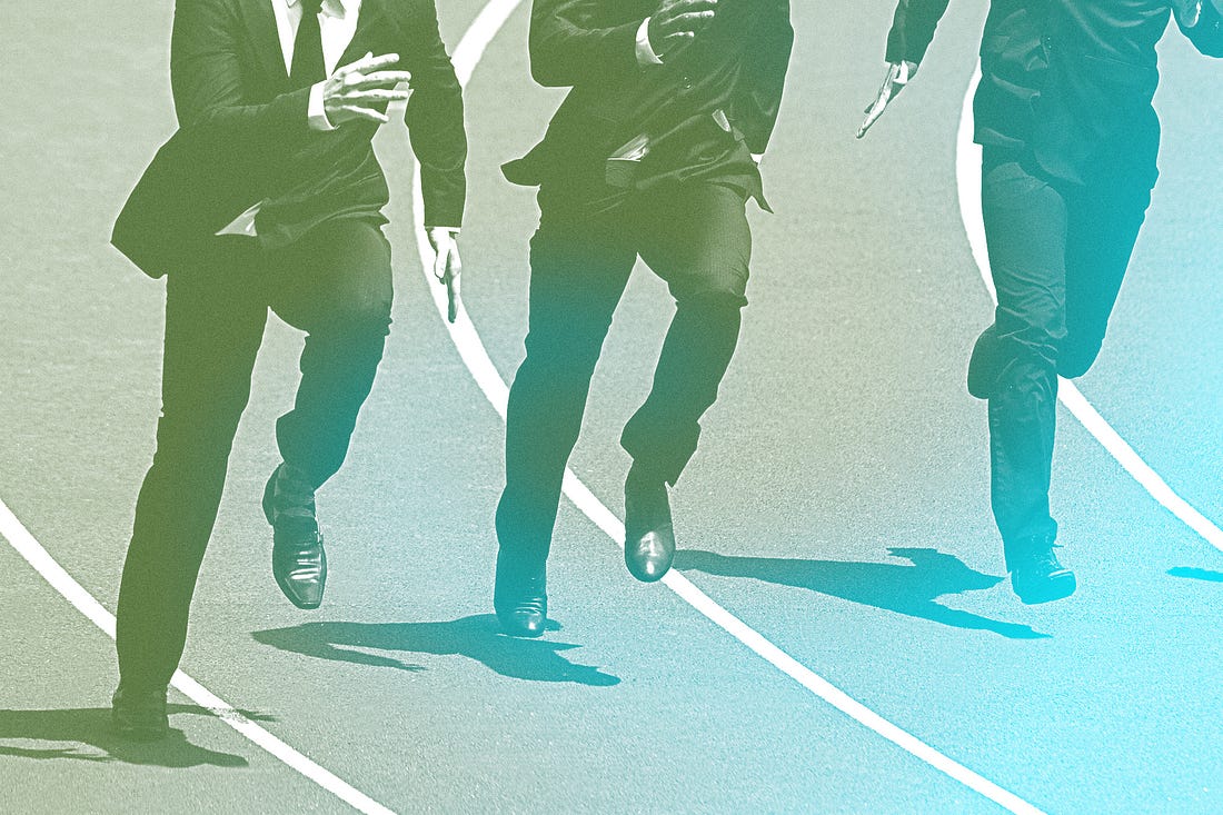 3 men in suits racing on a track