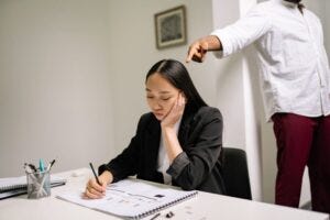 An abuser pointing at his female victim