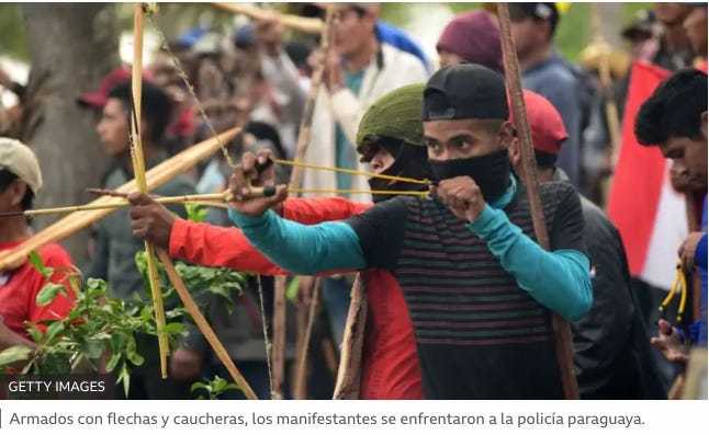 A group of people holding sticks and bow

Description automatically generated