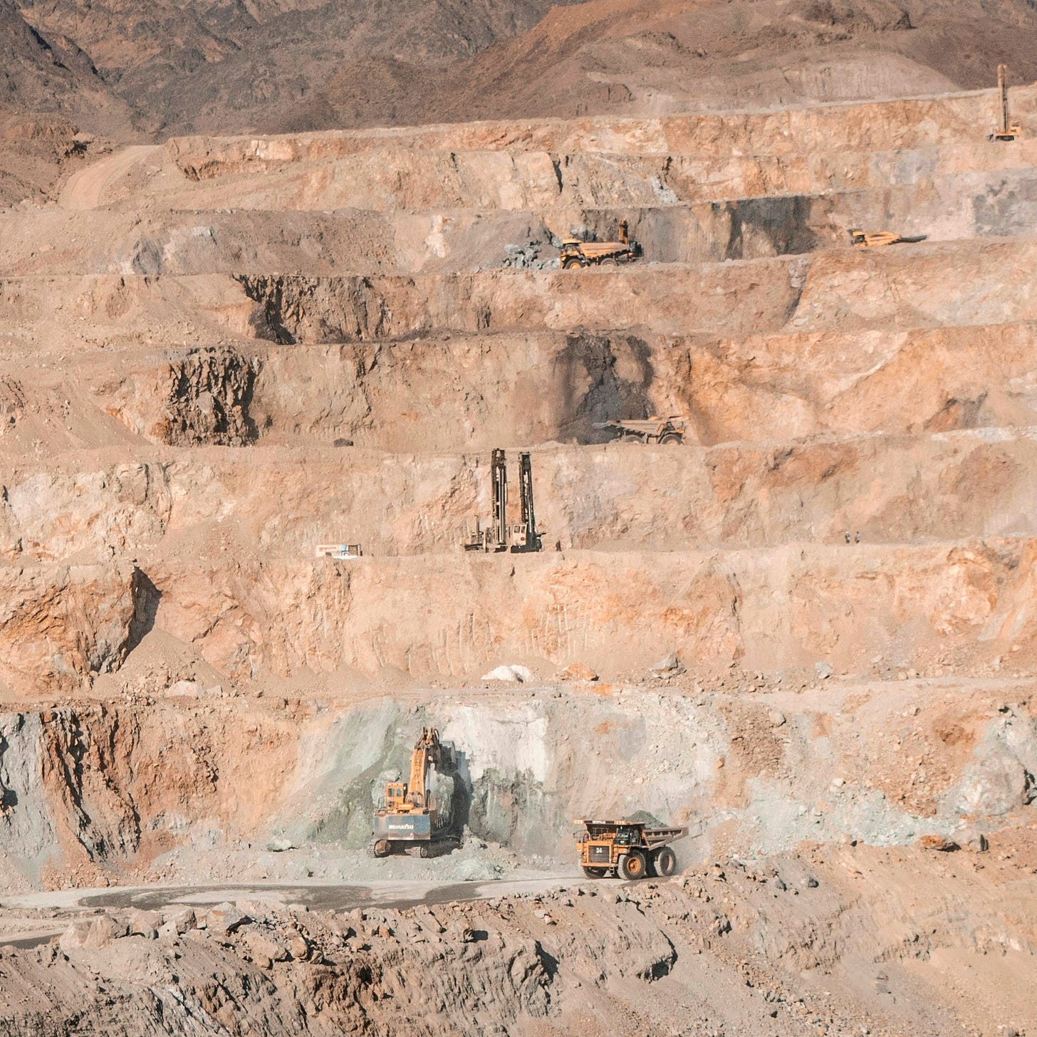 a few vehicles in a quarry a few vehicles in a quarry
