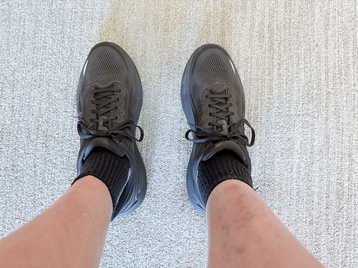View of legs and black sneakers, marking first walk without medical boot after injury recovery View of legs and black sneakers, marking first walk without medical boot after injury recovery