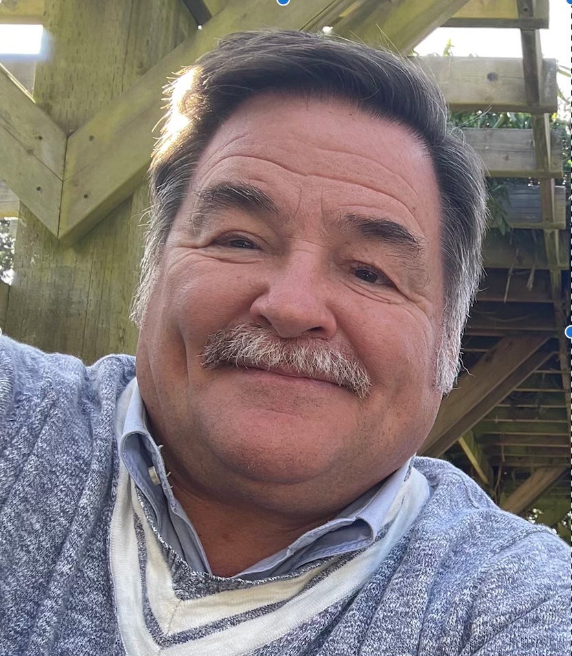 Selfie of a man with dark hair and moustache