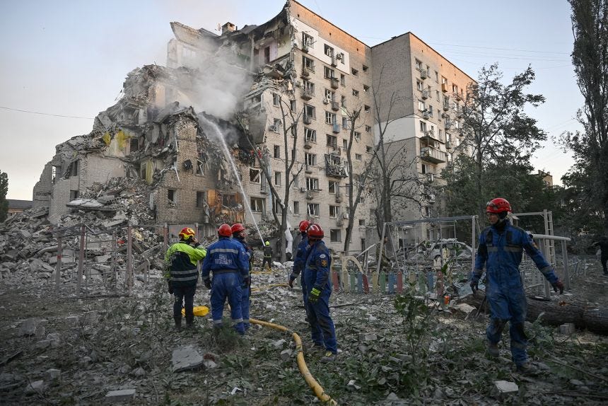 Rescuers extinguish a fire and work in a damaged residential building following missile strikes on the Ukrainian capital of Kyiv on July 2, 2026.